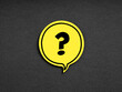 Question mark symbol on yellow speech bubble on black background. Problem, solution, query or brainstorming