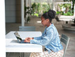 © Austockphoto - Young African woman using a computer on university campus