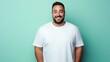 © Rachel Yee Laam Lai - joyful young hispanic plus size body positive male man boy guy 30s in white blank design casual t-shirt posing color background studio portrait, ai
