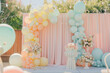 A colorful archway made of balloons is set up in a park. The balloons are in various pastel colors. The archway creates a festive and joyful atmosphere, wedding or birthday party backdrop.