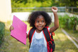 © Art_Photo - Back-to-school season with african american kid girl on the move with book and colorful school backpack, children, education, student go to school, study and learn at primary school