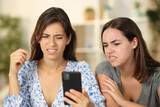 Fototapeta Tematy - Two friends watching nasty content on phone