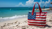 Bag with American flag colors near ocean on the sandy beach - USA patriotic holidays background