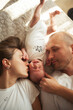 © Westend61 - Parent lying on bed with baby boy at home