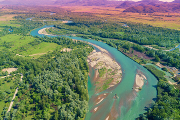 Canvas Print - Winding river in the valley on a sunny day. Panoramic view from above of mountain valley. Nature landscape. Tisza river, Zakarpattia Oblast, Ukraine