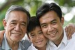 Three generations of smiling Asian men with greenery in the background.