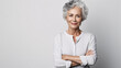 Senior woman with grey hair standing over white background skeptic and nervous.