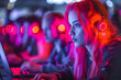 A young woman with red hair and a headset focused on her computer work in an illuminated room