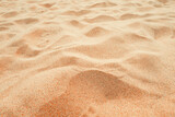 Fototapeta  - Beach sand background, close up, Low angle view of brown sandy surface in tropical resort. Vacation and summer holiday concept.