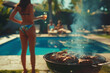 Lifestyle photo of friends having an outdoor barbecue in the backyard with a pool party background. A woman is grilling meat on a grill barbecue at home during summer vacation.