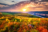Fototapeta Natura - Colorful sunset and blooming meadow in golden evening light near Dniester river.