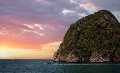 Wall Mural - Cliff and the clear sea with boat  Phi Phi island in south of Thailand on sunset