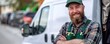 Confident gardener with beard and cap posing in front of service van
