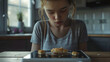 An unhappy depressed girl with a piece of food on the plate. Eating disorder, anorexia, or dieting problems. No appetite.