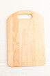 Empty rectangular wooden cutting board on white wooden. Top view