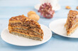 Walnut and hazelnut cake with caramel on blue wooden. side view, copy space, selective focus.