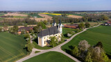 Fototapeta Miasta - Heiligenkreuz , Upper Austria, Austria - 04.13.2024: church of Heiligenkreuz in Upper Austria, aerial photography