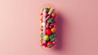 Script of multi-colored fruits, vegetables and nuts inside a capsule on a pink background. Conceptual print for healthy eating, vitamins or fitness.