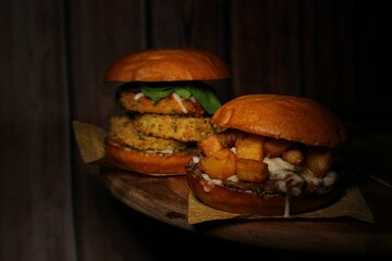 Wall Mural - Tasty cocked Chicken sandwich with sauce on wooden table