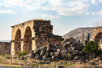 Wall Mural - Ruins of Hierapolis Basilica Baths with arches and hillside. Pamukkale, Denizli, Turkey (Turkiye)