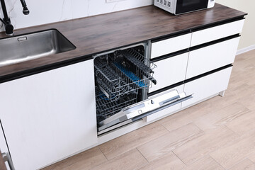 Canvas Print - Built-in dishwasher with open door in kitchen, above view