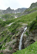 waterfall in mountains. landscape natural background. scenic nature view with mountains. journey, hiking, trekking, adventure concept. Caucasus mountains, Arkhyz