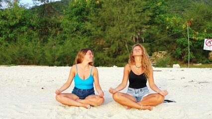 Beautiful shot of two females relaxing at the beach in Koh Phangan, Thailand