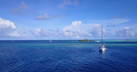 Sticker - Beautiful view of a boat in a calm blue sea on a sunny day