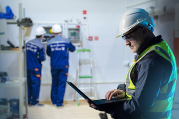 Poster - man engineer. factory technologist with laptop. factory engineer man stands in workshop. worker insi