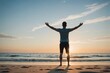 Rear view of man practicing tree pose with arms outstretched at beach in front of copy space