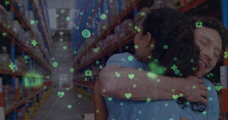 Poster - image of icons floating over happy diverse female and male warehouse workers hugging