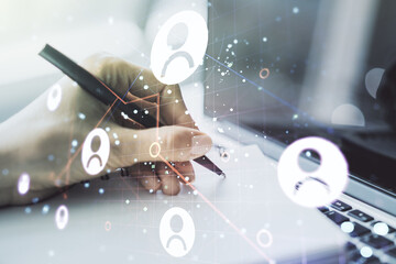 Poster - Double exposure of social network icons concept with hand writing in notebook on background with laptop. Marketing and promotion concept