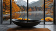 A large window in the bathroom overlooked autumn trees and mountains, with a black bathtub placed on the floor of gray tiles. Created with Ai