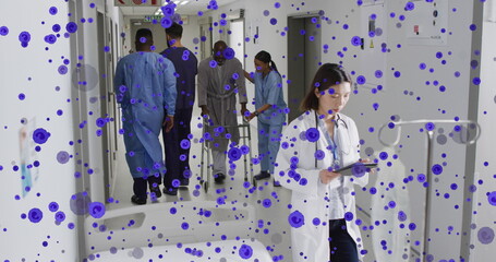 Wall Mural - Image of spots over diverse doctors at hospital