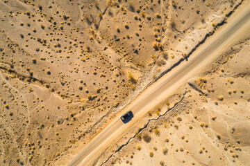 Desert road, Aerial image of a two lane road surrounded by dry desert landscape. Top view.