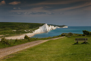 Wall Mural - A seat looking over the whits iconic cliffs of The Seven Sisters at Cuckmere Haven in Sussex UK