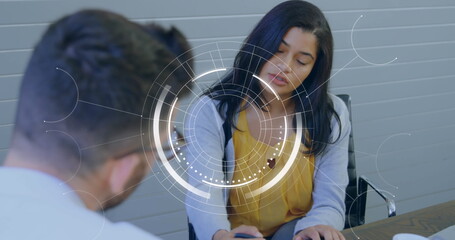 Poster - Image of round scanner against diverse man and woman discussing over a document at office
