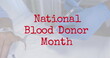 Image of national blood donor month over hands of doctor