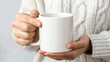 © Yuwarin - Girl is holding white mockup mug ceramic cup in hand isolated on white background