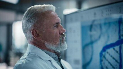 Leinwandbilder - Portrait of a Middle Aged Professor Focused on Work at Modern Medical Research and Treatment Development Laboratory. Bioengineer Using a TV Display to Look at a Gene Therapy Report Made By His Team