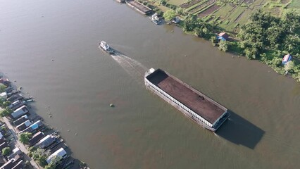 Wall Mural - aerial view of a coal barge passing through a South Kalimantan river