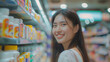 Smiling  asian woman at the pharmacy, in drugstore, store,  buying vitamins