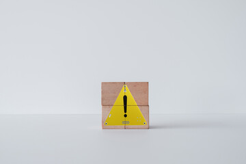 Notification,Stop,Exclamation mark,Attention sign,Reminder,warning sign concept.,Exclamation mark on yellow triangle sign on wooden cubes over white background.