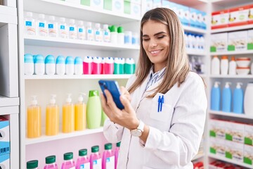 Sticker - Young beautiful hispanic woman pharmacist using smartphone working at pharmacy