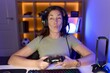 Beautiful brunette woman playing video games wearing headphones making fish face with lips, crazy and comical gesture. funny expression.