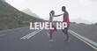Image of the words level up written in white over couple exercising on mountain road
