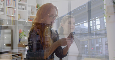 Poster - Image of caucasian businesswoman walking and using smartphone