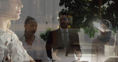 Poster - Image of caucasian businesswoman using computer over diverse business people talking