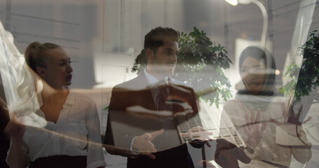 Poster - Image of caucasian businesswoman using computer over diverse business people talking
