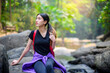 attractive happy asian woman backpacker travel and relax in green forest national park